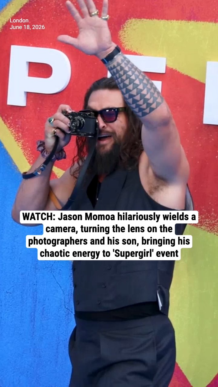 WATCH: Jason Momoa hilariously wields a camera, turning the lens on the photographers and his son, bringing his chaotic energy to 'Supergirl' event