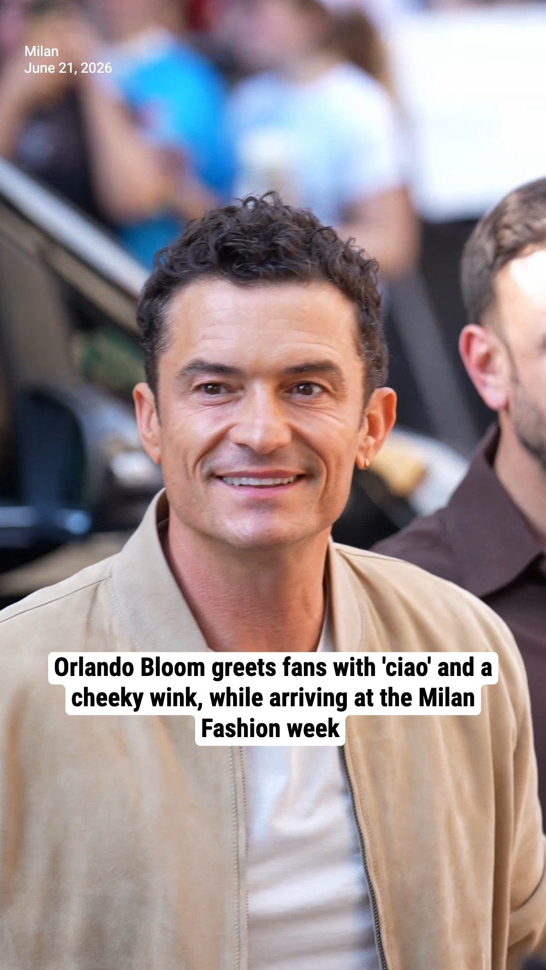 Orlando Bloom greets fans with 'ciao' and a cheeky wink, while arriving at the Milan Fashion week