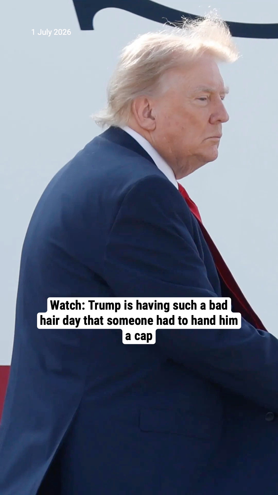 Watch: Trump is having such a bad hair day that someone had to hand him a cap