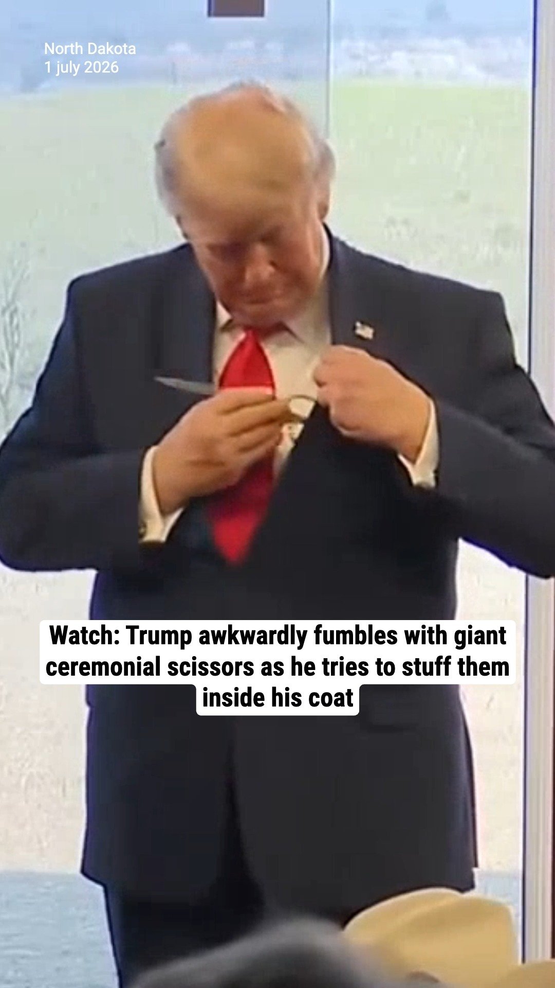 Watch: Trump awkwardly fumbles with giant ceremonial scissors as he tries to stuff them inside his coat